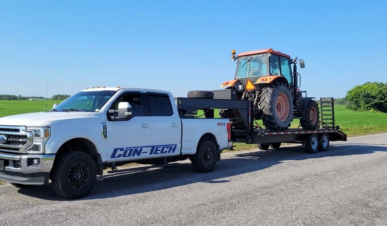 Con-Tech Mechanical mobile service hauling a tractor